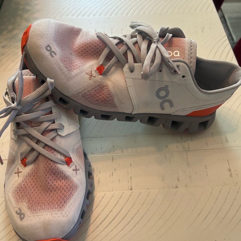 On Running White and Orange Sneakers